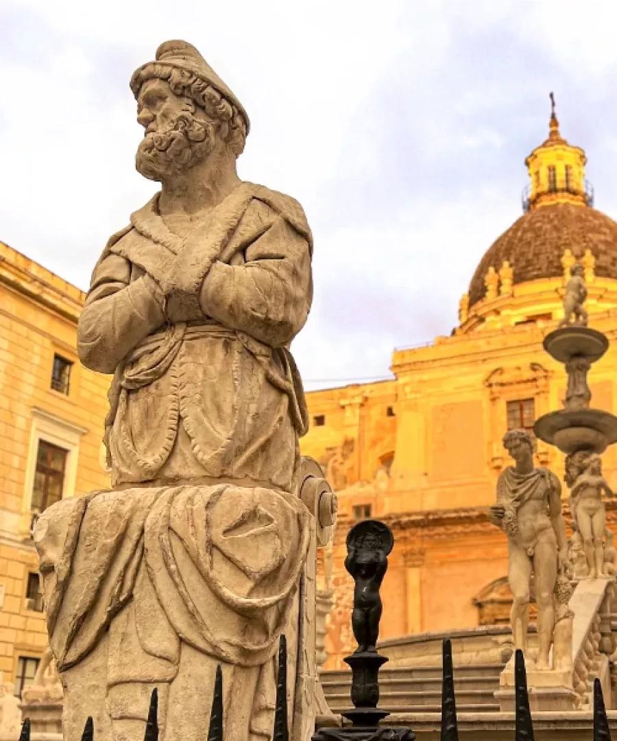 Statue near Palermo Cathedral under warm evening light