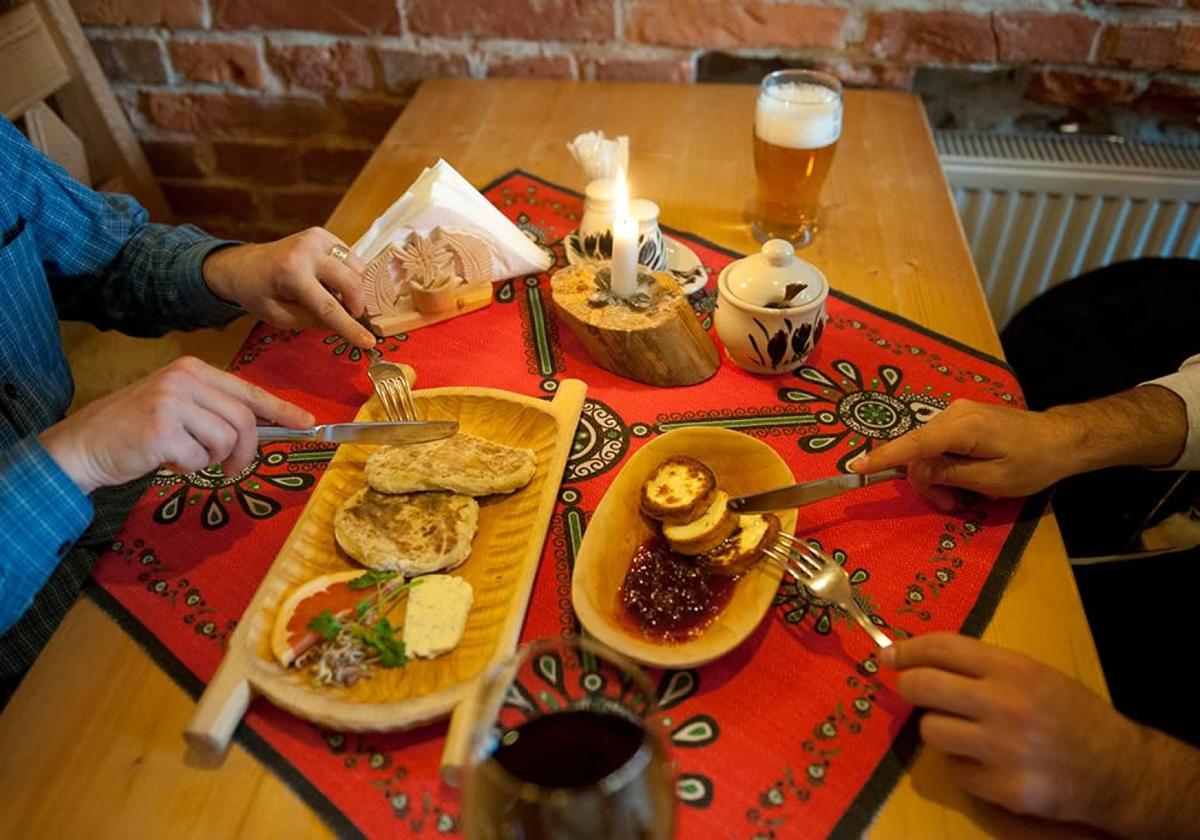 Table of Polish dishes including pierogi and oscypek during the food tour