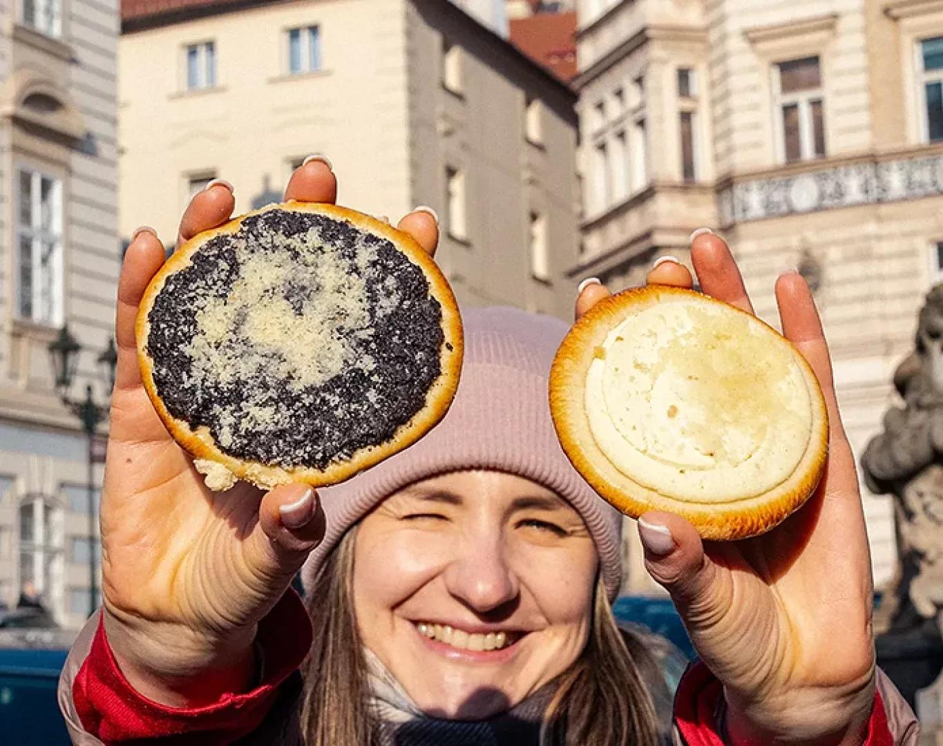 Guest holding traditional pastry treats during a food tour experience
